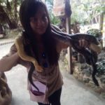 Our guest trying to smile with the pythons